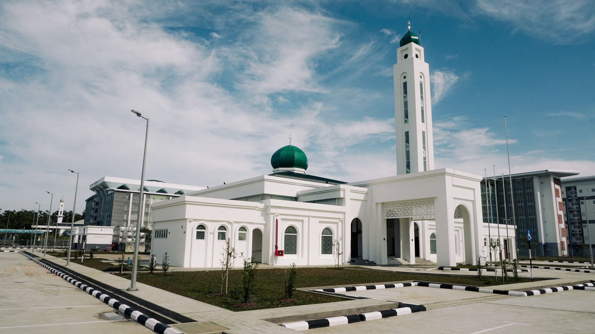 Masjid Baru RPN Kg Rimba seen from the car park, with the green dome and minaret above the entrance portico
